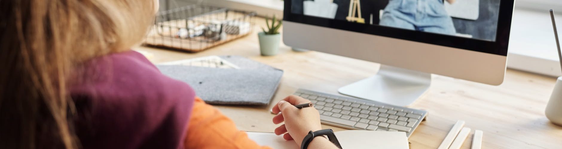 photo of girl watching through imac