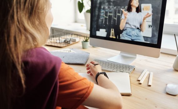 photo of girl watching through imac